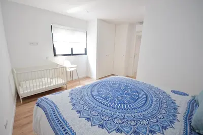 a bedroom with a blue and white blanket on a bed at Blue Horizons, (AT18) 2 Bedroom, Olhos de Agua in Olhos de Água
