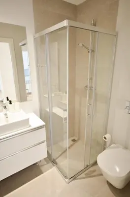 a bathroom with a shower and a toilet at Blue Horizons, (AT18) 2 Bedroom, Olhos de Agua in Olhos de Água