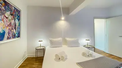 a bedroom with a white bed with two pillows on it at Que sonho! Vista Marina T2 HsR Vilamarina in Vilamoura