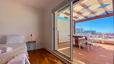 a bedroom with a bed and a balcony with a view at Que sonho! Vista Marina T2 HsR Vilamarina in Vilamoura