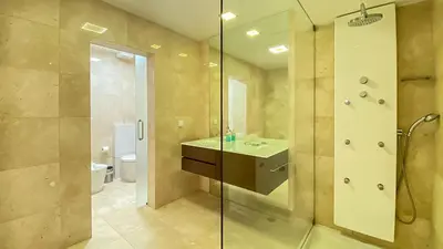 a bathroom with a sink and a glass shower at Que sonho! Vista Marina T2 HsR Vilamarina in Vilamoura