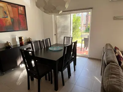 a dining room with a black table and chairs at House´s Golf in Almancil