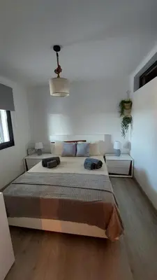 a bedroom with a large bed in a room at Casa Azinheira - Albufeira in Albufeira