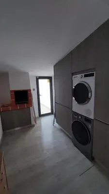 a kitchen with a washing machine in a room at Casa Azinheira - Albufeira in Albufeira
