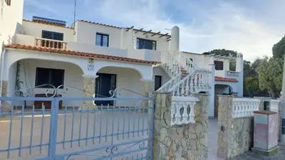 a white house with a fence in front of it at Casa Azinheira - Albufeira in Albufeira