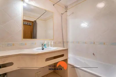 a bathroom with a sink and a mirror and a tub at #166 Frat Apartment by Home Holidays in Albufeira