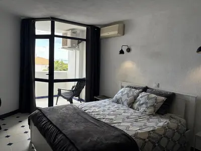 a bedroom with a bed and a door to a balcony at Coral By Albufeira Rental in Albufeira