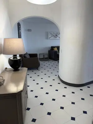 a living room with a couch and a table with a lamp at Coral By Albufeira Rental in Albufeira