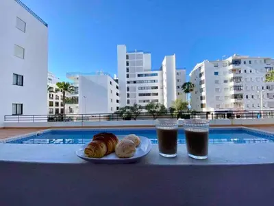 a plate of food and two glasses of soda at Luxury Modern Beach Apartment in Quarteira