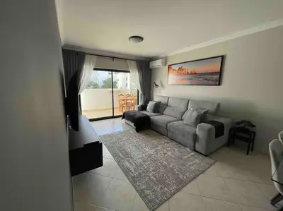 a living room with a couch and a table at Luxury Modern Beach Apartment in Quarteira