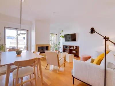 a dining room and living room with a table and chairs at AL - Quarteira Terrace Penthouse in Quarteira