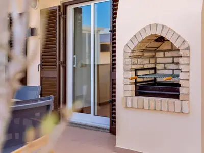 a brick oven on the side of a house at AL - Quarteira Terrace Penthouse in Quarteira