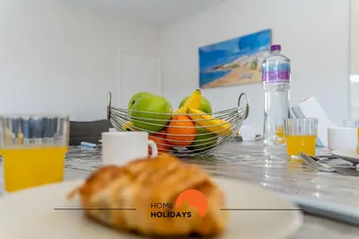 a table with a bowl of fruit and a plate of bread at #164 Saradel 42 by Home Holidays in Albufeira