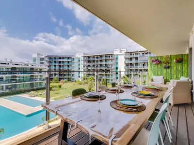 a dining room with a table and a pool at AL - Residence Golf Club Modern Apartment in Vilamoura