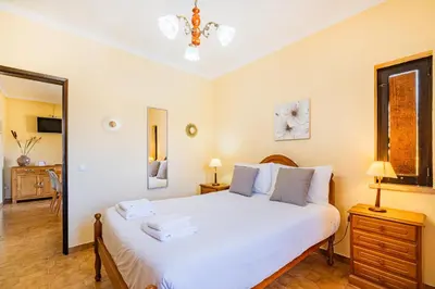 two beds in a room with a window at Villa Pinheiro in Albufeira