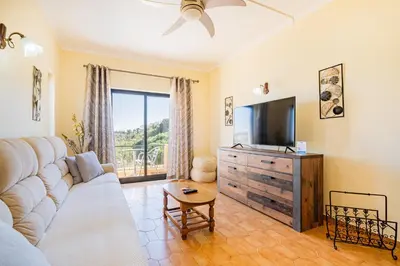 a living room with a couch and a tv at Villa Pinheiro in Albufeira
