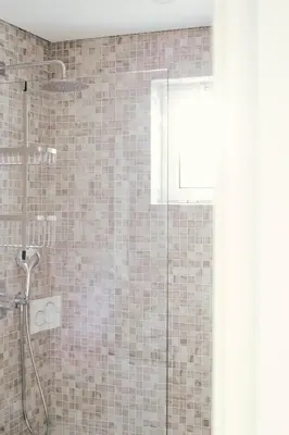 a bathroom with a shower with a glass door at Orange Boutique Residence - Casa Diogo in Quarteira