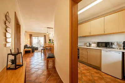 a kitchen and living room with a table at BeGuest Jardins Vale Parra Apartment in Albufeira