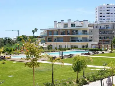 a large building with a swimming pool in a park at Green 1 Apartment by Stay ici Algarve Holiday Rental in Albufeira
