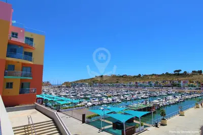 a marina with a lot of cars in a harbor at Camelia 52 Beach Studio Apartment - São Rafael, Albufeira in Albufeira