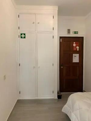 a bedroom with a large white closet next to a door at Happydreams apartment in Albufeira in Albufeira