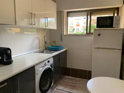 a kitchen with a washing machine and a sink at Happydreams apartment in Albufeira in Albufeira