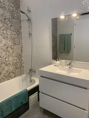 a bathroom with a sink and a tub and a sink and a mirror at Happydreams apartment in Albufeira in Albufeira
