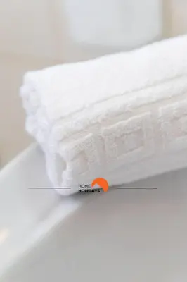 a stack of white towels sitting on a counter at #132 Velamar 414 by Home Holidays in Albufeira
