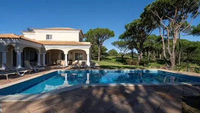a kitchen with white cabinets and a checkered floor at Casa Atlantico in Quinta do Lago