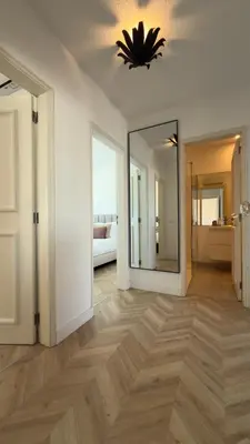 a kitchen with green cabinets and stainless steel appliances at Penthouse S.Jorge Seaview T4 in Quarteira