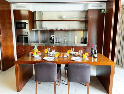 a kitchen with a large wooden table with chairs at Outstanding Condo- Beach, Pool & Golf by BeCherish in Galé