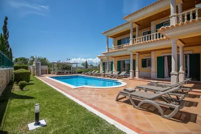 a villa with a swimming pool and a house at Villa Iris in Albufeira