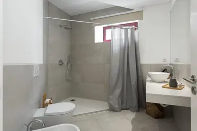 a bathroom with a shower and a toilet and a sink at Madalena Village 1 - City centre by HD PROPERTIES in Faro