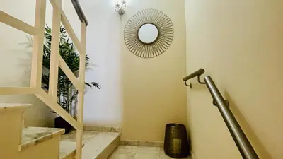 a room with a staircase with a mirror and a mirror at Vale Pedras by Check-in Portugal in Albufeira