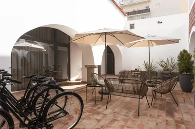a group of bikes parked on a patio with umbrellas at Madalena Village 4 - City centre by HD PROPERTIES in Faro