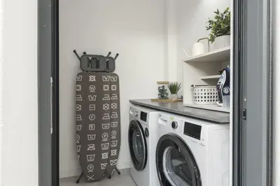a laundry room with a washer and dryer at Madalena Village 5 - City centre by HD PROPERTIES in Faro
