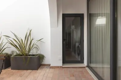 a black door on a building with plants at Madalena Village 7 - City centre by HD PROPERTIES in Faro