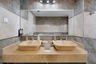 a bathroom with two sinks and a mirror at Elegance Apartment W/ Balcony & Pool by LovelyStay in Albufeira