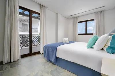 a bedroom with a large bed and a window at Elegance Apartment W/ Balcony & Pool by LovelyStay in Albufeira