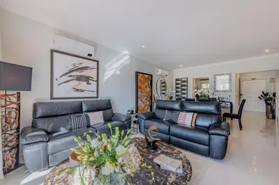a living room with two leather couches and a table at 5 star Luxury Palmview apartment with large terrace and communal pool in Quarteira