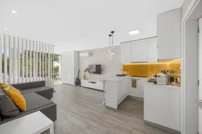 a living room with a couch and a kitchen at Silver Lux Studio 1 - City Center by HD PROPERTIES in Vilamoura