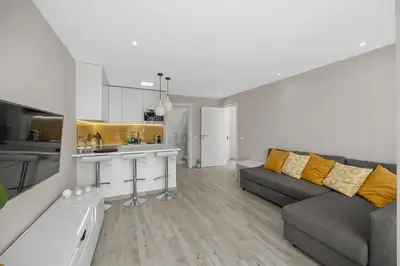 a living room with a couch and a kitchen at Silver Lux Studio 1 - City Center by HD PROPERTIES in Vilamoura