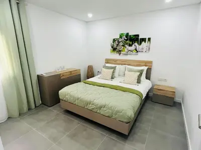 a bedroom with a large bed in a room at Happy Sunrise in Albufeira
