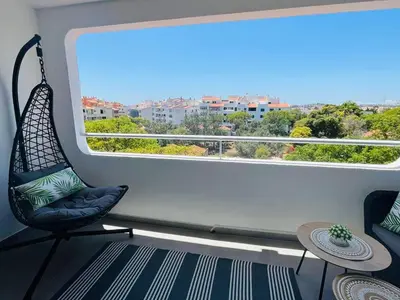 a room with a chair and a large window at Happy Sunrise in Albufeira