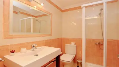 a bathroom with a sink and a toilet and a shower at Villa Nuki- CleverDetails, quiet location, sleeps 8, private pool in Vilamoura