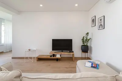 a living room with a couch and a tv at Centralgarve - Premium Apartment in the Center of Vilamoura - Cota10 in Vilamoura