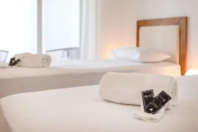 a hotel room with two beds with towels on the bed at Centralgarve - Premium Apartment in the Center of Vilamoura - Cota10 in Vilamoura