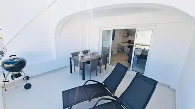 a room with a table and chairs and a dining room at Your dream Getaway Awaits in Vale do Lobo in Almancil