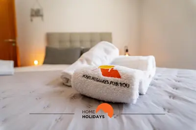 a towel on top of a bed in a room at #172 Falésia Beach by Home Holidays in Albufeira