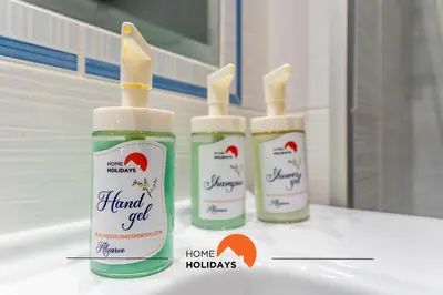 three bottles of hand lotion sitting on a bathroom counter at #172 Falésia Beach by Home Holidays in Albufeira